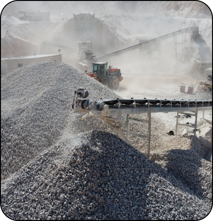 Image of a limestone quarry with machinery and piles of limestone